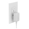 Side view of Belkin 20W compact charger plugged into wall
